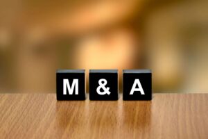 Dirigeants de deux entreprises se serrant la main lors de la signature d'une opération de fusion-acquisition
